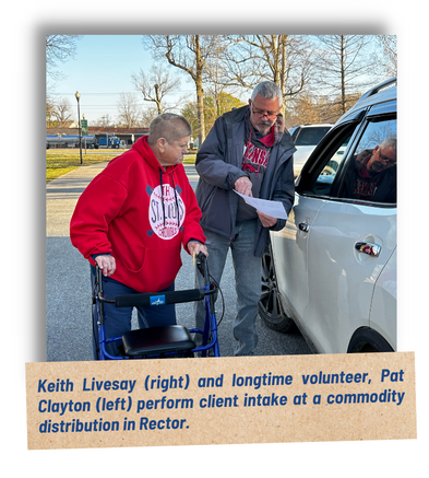 Keith Livesay (right) and longtime volunteer, Pat Clayton (left), perform client intake at a commodity distribution in Rector.